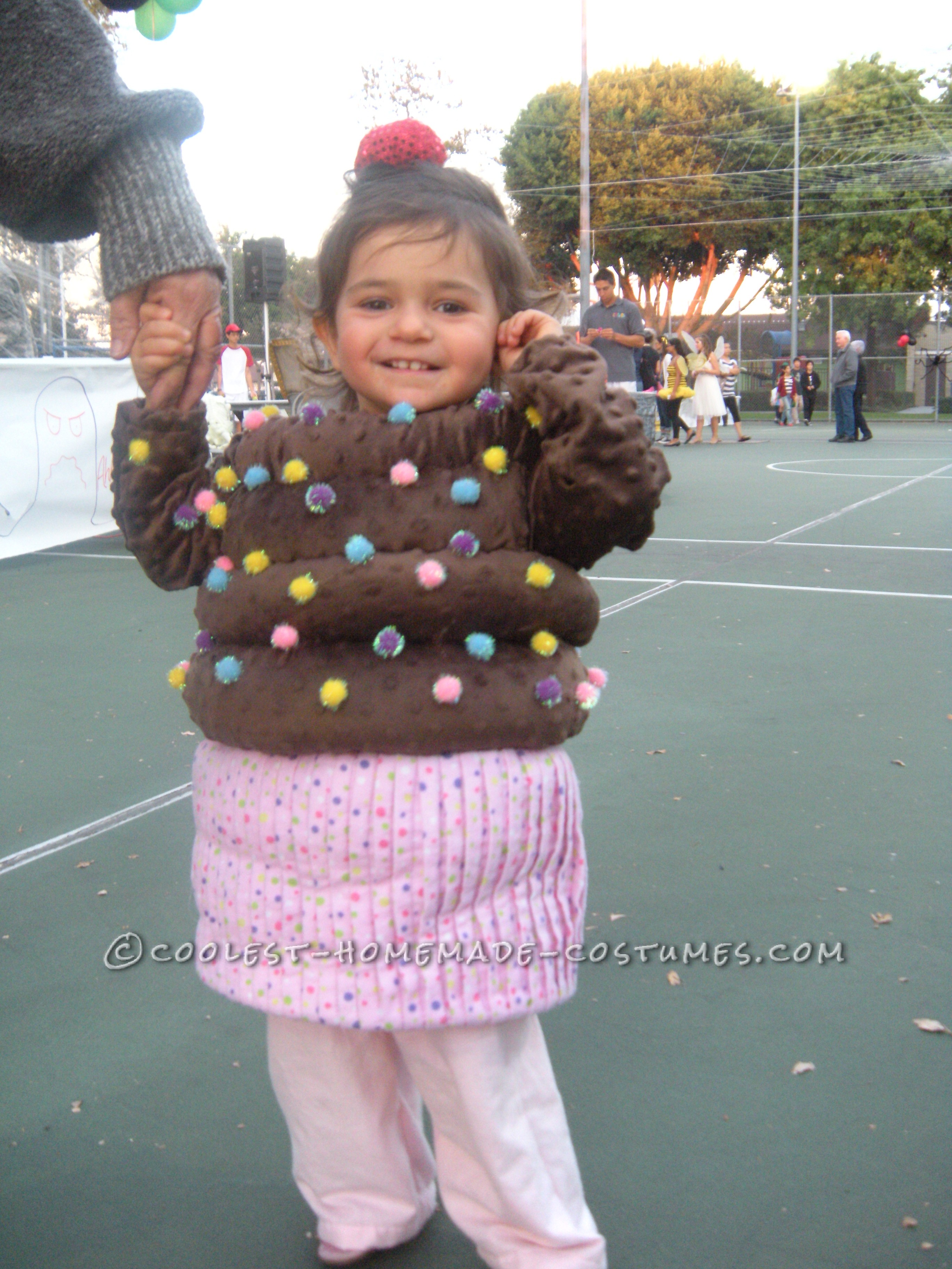 The Cuppy Cake costume was easy to make. The bottom is flannel material, pink with small colored dots and I pleated the material to make it look like