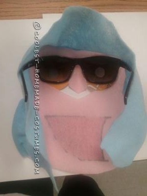 I made the face out of hard felt, sunglasses hot glued behind it lenses covered with white paper and just small whole to see through as the eyes, the