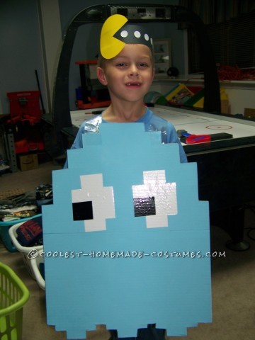 My son wanted to be a light blue Pac Man ghost for Halloween. I took a large piece of cardboard and cut it to shape (I looked at images online to fig