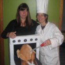 My wife and I are pictured here last Halloween…I’m the one on the left, wearing the oven and thrusting forth my five-month pregnant bell