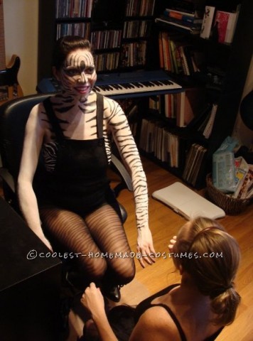 I used white make up as a base and a black makeup crayon to draw on all the stripes on her arms, back and chest.  For her face, I used special f