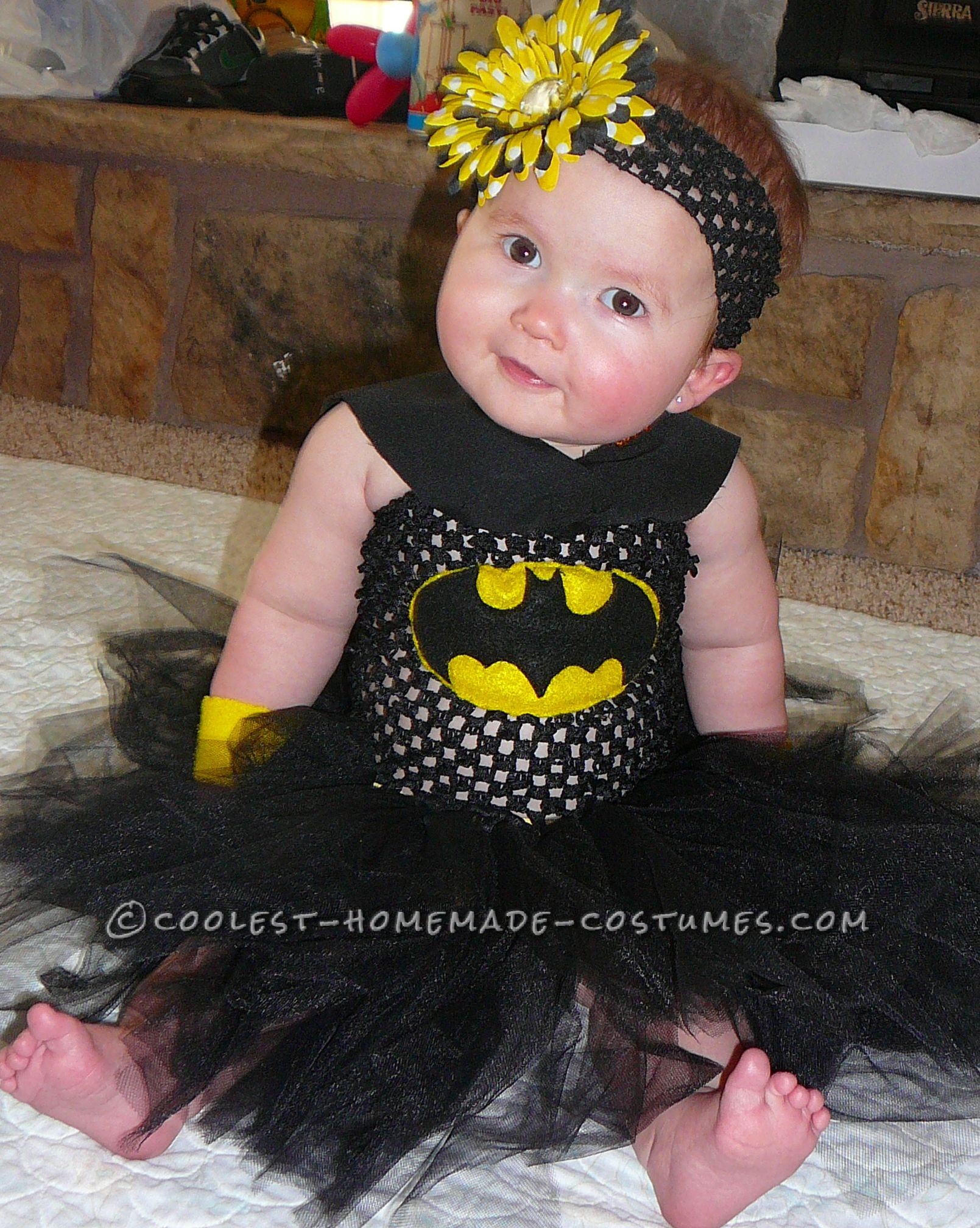 Pretty simple, just a black tutu dress. I made the bracelets from flannel, and the bat logo was made from felt and sewn on. I sewed on the bottom hal