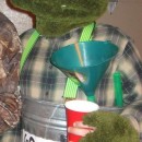 Fun Homemade Oscar the Grouch Halloween Costume: I got most of my materials for Oscar the Grouch costume at Wallmart! The green fur is made out of green bath rugs. I had an old wire hanging flower p