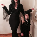 Cool Homemade Mom and Daughter Couple Costume: Morticia and Wednesday Addams with Thing