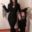 Cool Homemade Mom and Daughter Couple Costume: Morticia and Wednesday Addams with Thing