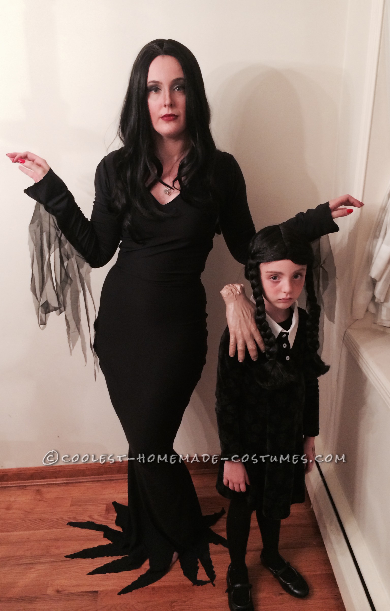 Cool Homemade Mom and Daughter Couple Costume: Morticia and Wednesday Addams with Thing