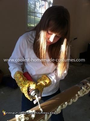 Spraying the 1st (bottom) layer of popcorn pieces, on a curved surface covered in plastic wrap